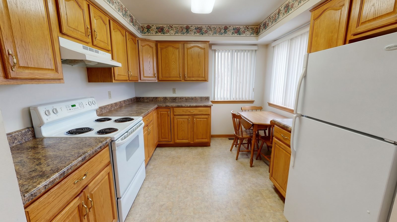 Before: dated oak kitchen with laminate counters prior to remodeling in Decatur, Atlanta